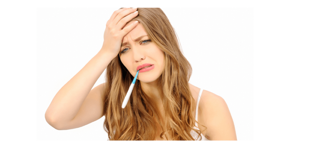 Young lady with right hand on head, with painful Digital thermometer in her mouthexpression