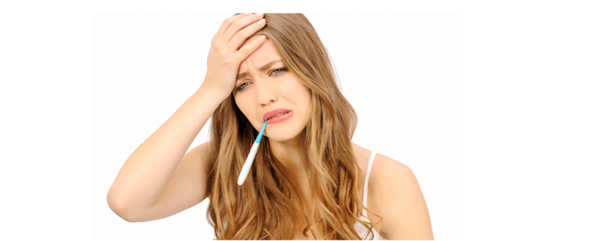 Young lady with right hand on head, with painful Digital thermometer in her mouthexpression